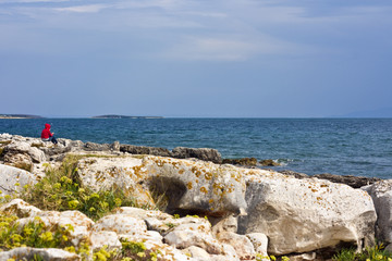 Woman sitting on seaside