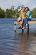 © Darren Baker - Happy Man and Woman Couple Sitting On A Pier By Lake