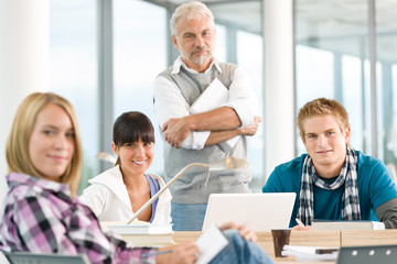 Wall Mural - High school - three students with mature professor