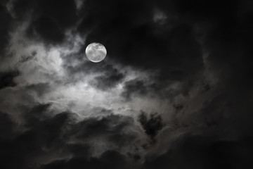 spooky full moon and eerie white clouds