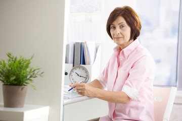 Poster - Mature office worker sitting at desk