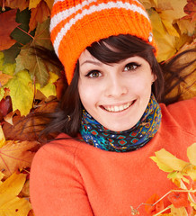 Wall Mural - young woman in autumn orange leaves.