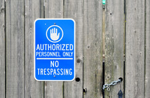 Authorized Personnel Only Sign On A Chained Old Wooden Fence.