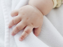 Close Up Of Mixed Race Baby GirlÕs Hand