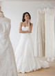 © JGI/Jamie Grill/Blend Images - Mixed race woman trying on wedding dresses