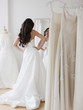 © JGI/Jamie Grill/Blend Images - Mixed race woman trying on wedding dresses