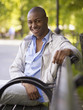 © Granger Wootz/Blend Images - African man smiling on bench