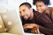 © Jack Hollingsworth/Blend Images - African couple using laptop on sofa