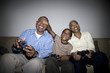 © Paul Burns/Blend Images - African grandparents playing video game with grandson