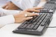 © PBNJ Productions/Blend Images - Hispanic woman typing on keyboard