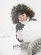 © JGI/Jamie Grill/Blend Images - Chinese girl building snowman