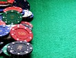 Poker chips on green felt background