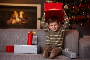 Little boy holding christmas present