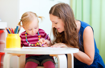 Mother and daughter drawing together