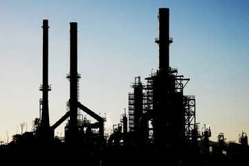 Wall Mural - Silhouette of an oil refinery with chimneys