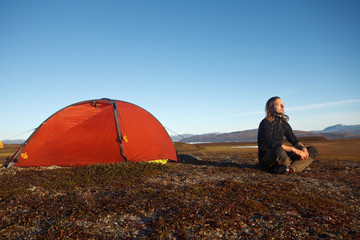 Wall Mural - hiker meditation in front of the tent