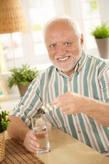 Sticker - Portrait of senior man taking medicine at home