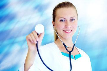 Smiling medical doctor with stethoscope on the hospitals backgro