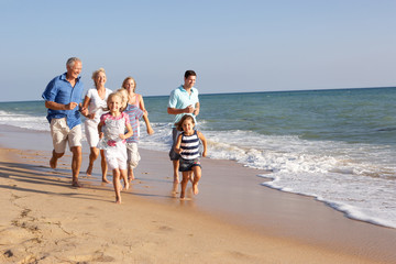 Portrait Of Three Generation Family On Beach Holiday