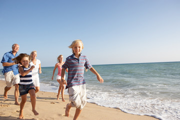 Portrait Of Three Generation Family On Beach Holiday