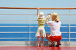 © Pavel Losevsky - behind mother and her daughter standing on deck of yacht