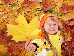 Wall Mural - child in autumn orange leaves.