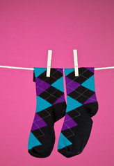 A pair of snazzy socks hanging on a line