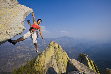 Wall Mural - Female rock climber rappelling.