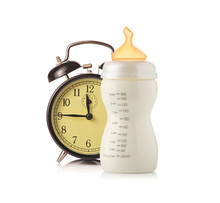 Alarm Clock And Baby Feeding Bottle With Milk