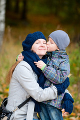 Canvas Print - Boy kissing his mother outdoor