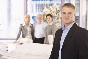 Poster - Young businessman in office with team