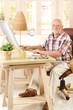 © nyul - Portrait of elderly man with computer