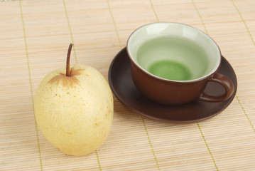 A pear with tea on bamboo