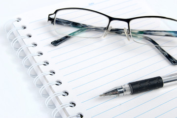 Canvas Print - Pen,notebook and glasses on white background