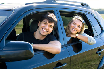 Wall Mural - happy young couple driving the car