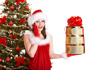 Christmas girl in santa hat holding stack  gift box.