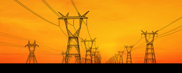 Electricity pylons and lines at dusk.