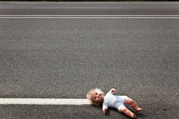 doll leave on a highway lane