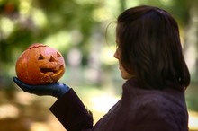 Woman With Pumpkin In Hand