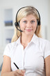 © goodluz - Closeup of blond woman with headphones and microphone