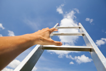 man scrambling by stairs to the sky