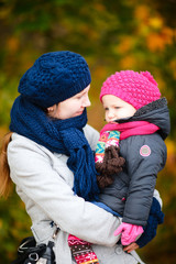 Wall Mural - Mother and daughter at autumn park