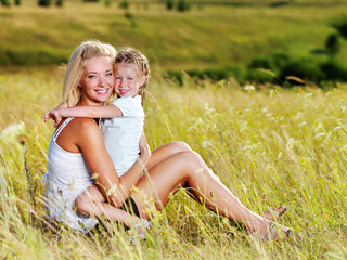 mother and little daughter on meadow