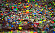 Close Up Of Brownies Covered In Chocolate Icing And Broken Candy