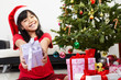 © Arto - Little girl pointing Christmas present