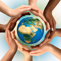 multiracial hands surrounding the earth globe