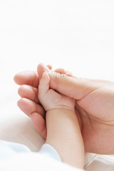 hand of the child in a hand of mother