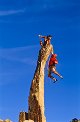 Wall Mural - Rock climbing team reaching the summit.