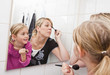 © gemenacom - Mother and daughter put on make-up