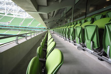 Many rows of folding seats in empty stadium